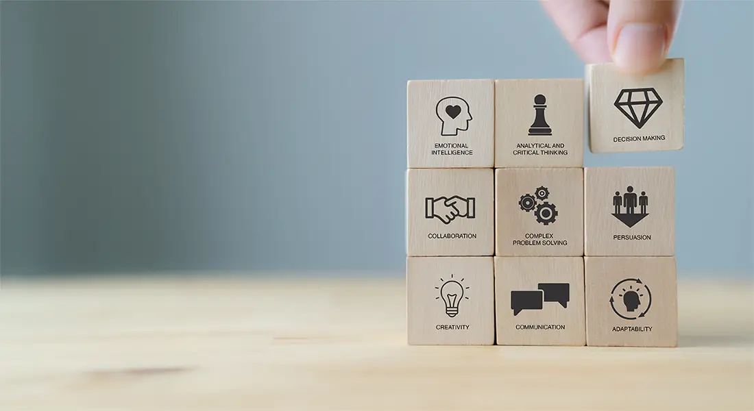 Soft skills concept. Hand puts wooden cubes with icons of SOFT SKILLS creativity, EQ, Problem solving, persuasion, collaboration, adaptability on grey background.